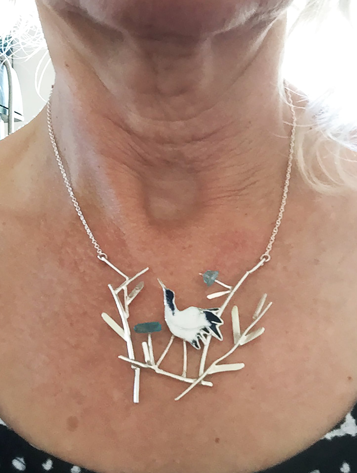 Crane with blue flowers necklace